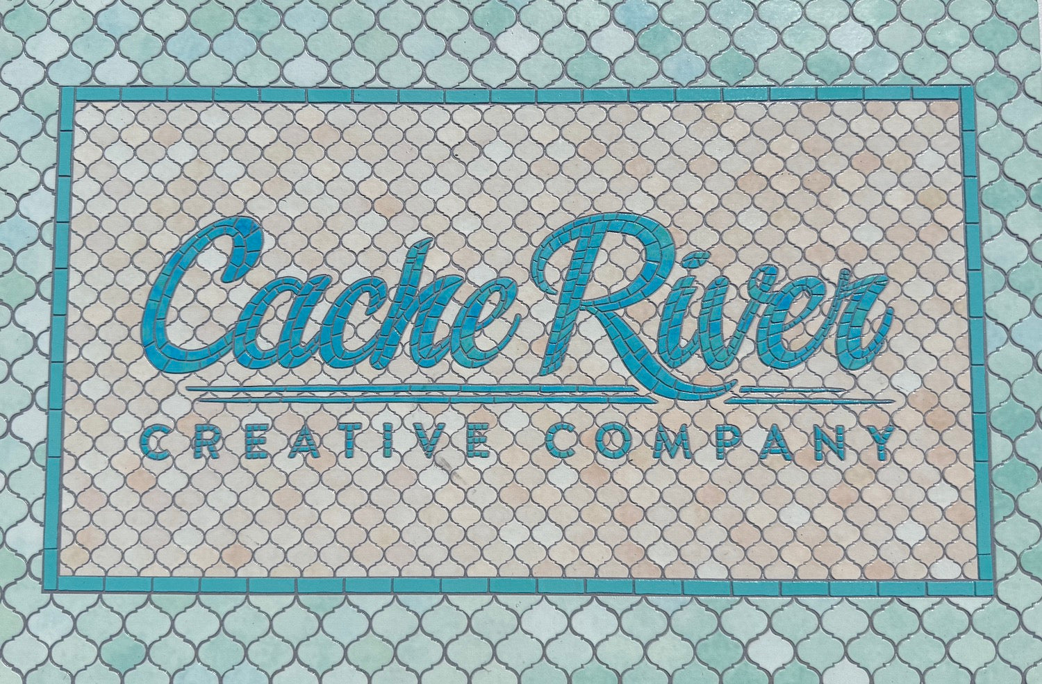 Logo of Cache River Creative Company on a textured background
